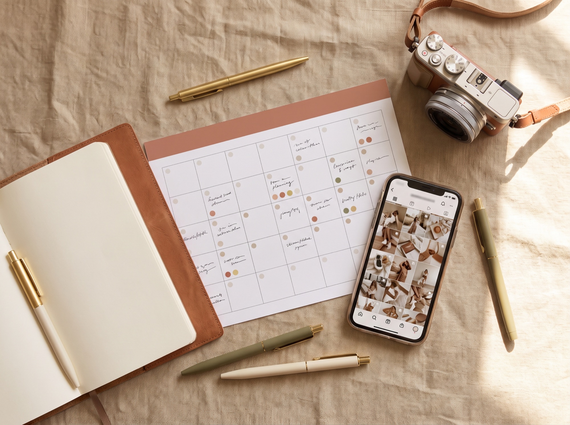 Content planning flat-lay with a social calendar and a phone feed