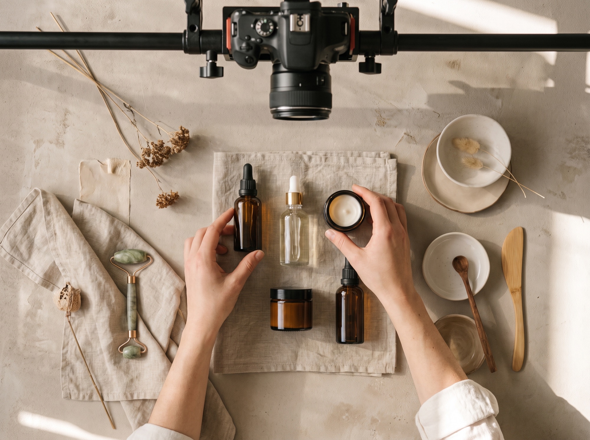 Overhead product and branding flat-lay photoshoot on a neutral surface