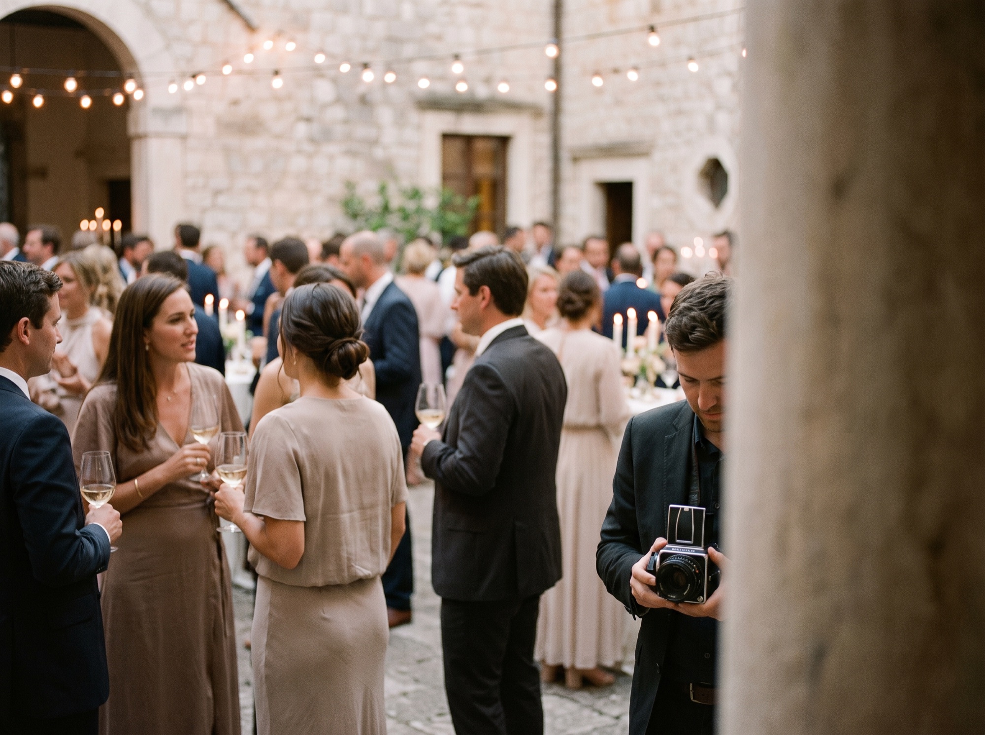 Photographer capturing a celebration event in warm ambient light
