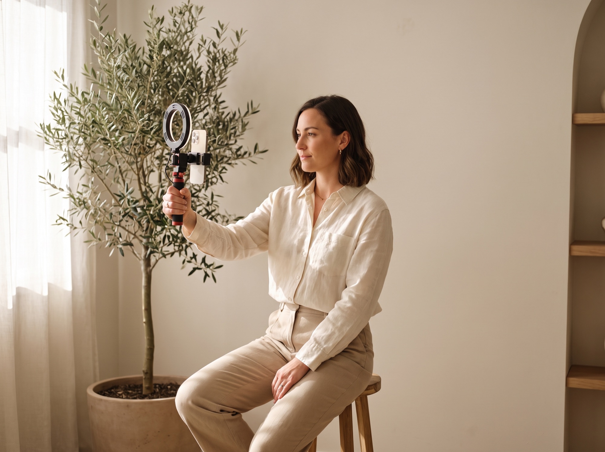 Creator filming vertical social video with a ring light in a studio