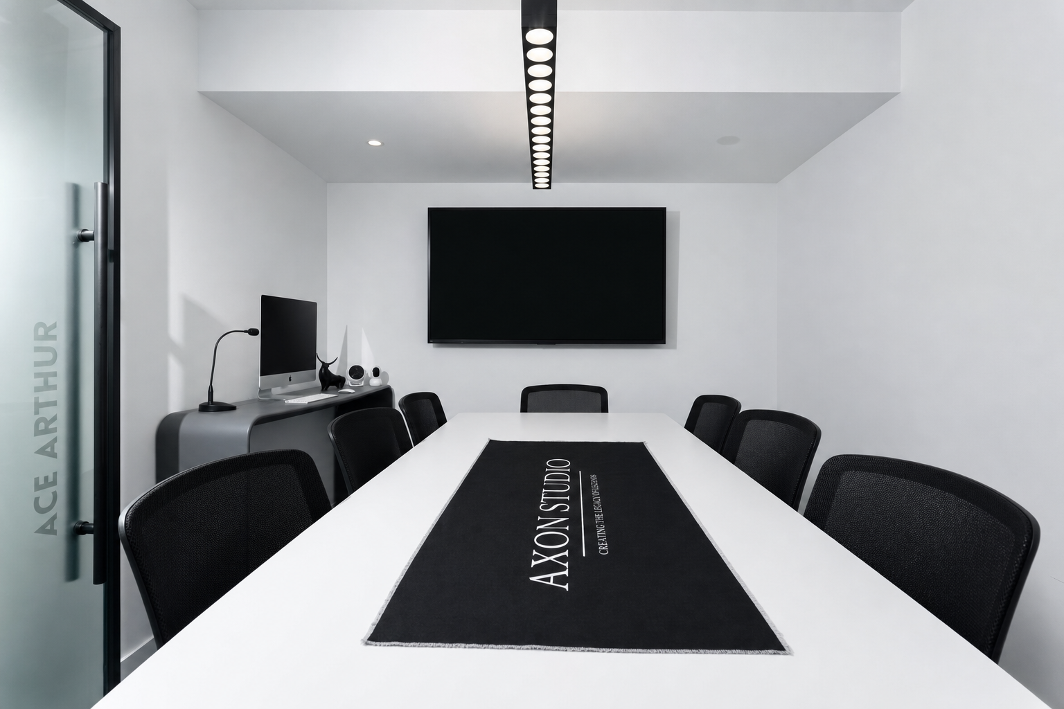 Black-and-white boardroom with a branded table runner