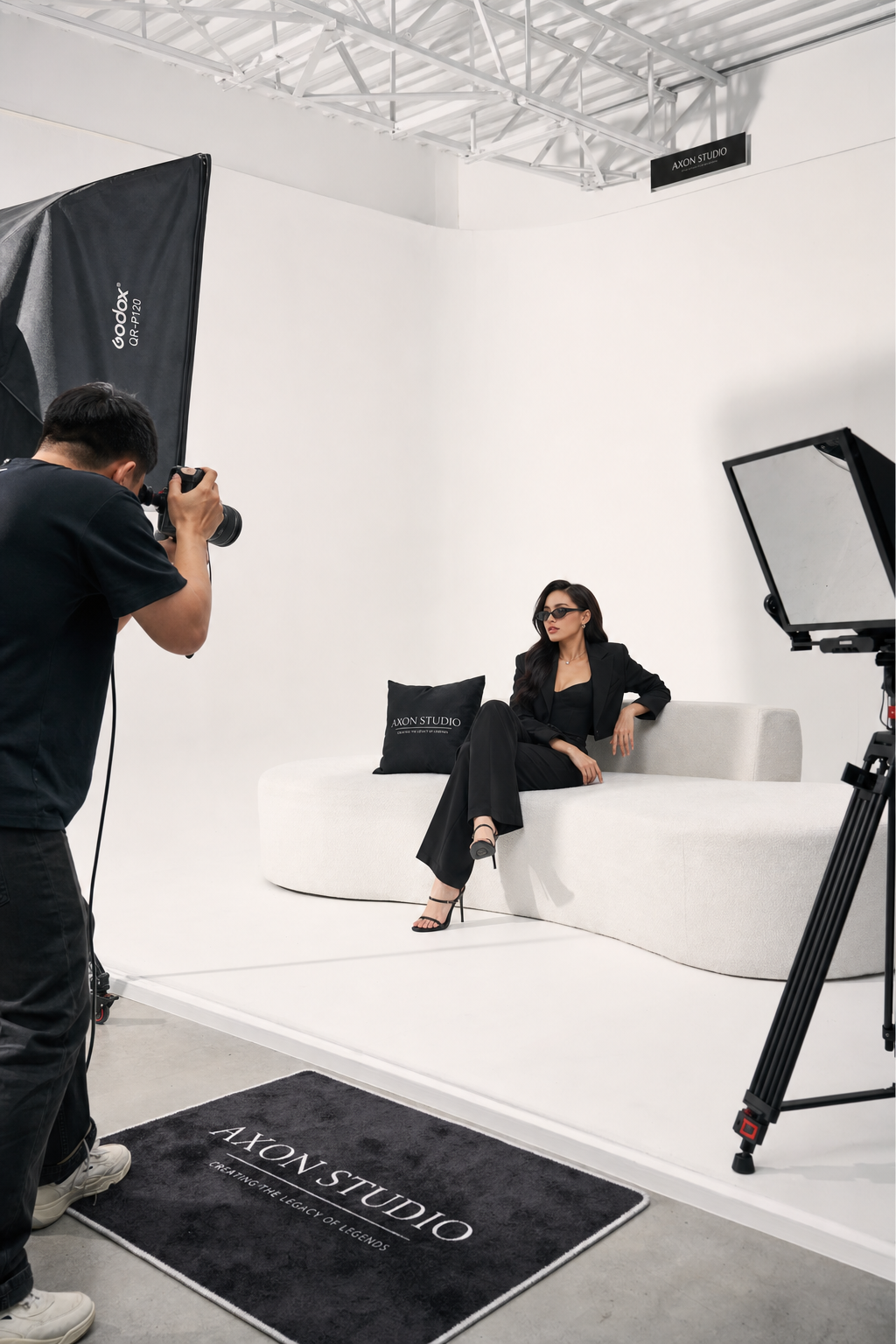 Model posing on the cyclorama sofa during a photoshoot