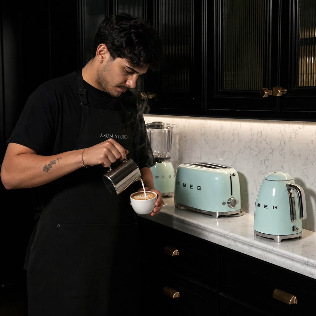 Barista pouring latte art at the black SMEG kitchen bar