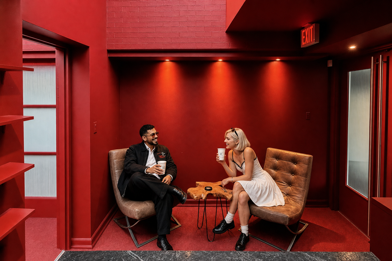 Friends laughing over coffee in the red lounge