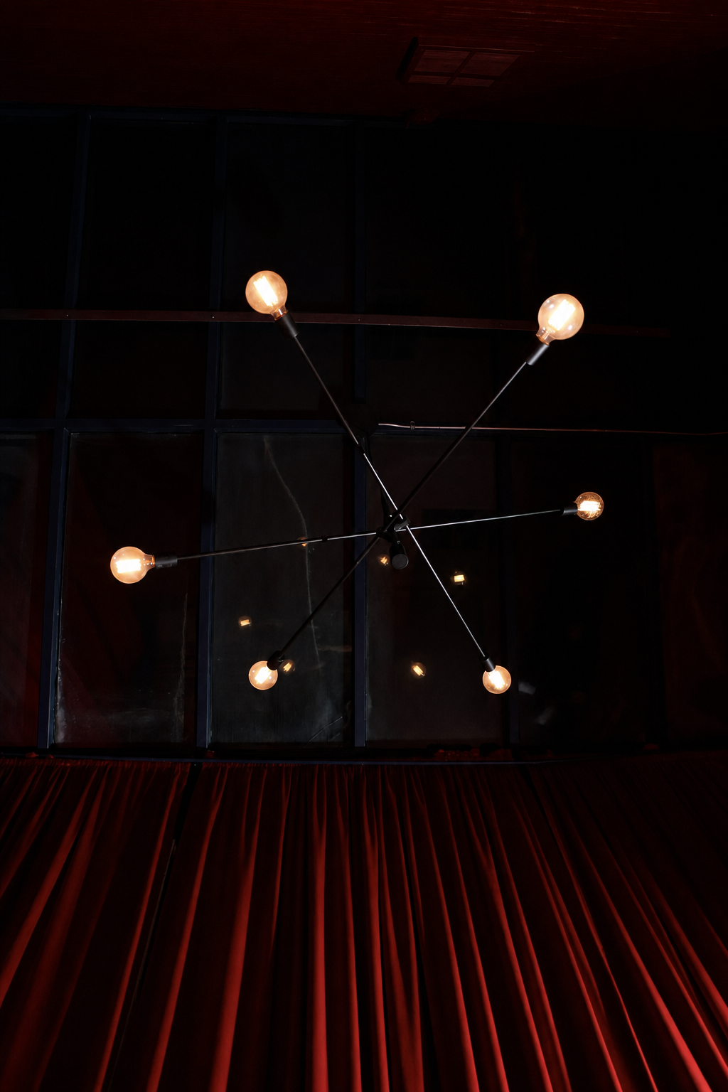 Sputnik chandelier with Edison bulbs against the skylight